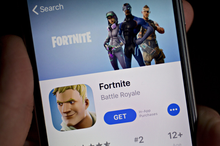 The Epic Games Inc. Fortnite: Battle Royale video game is seen in the App Store on an Apple Inc. iPhone displayed for a photograph in Washington, D.C., U.S., on Thursday, May 10, 2018. Fortnite, the hit game that's denting the stock prices of video-game makers after signing up 45 million players, didn't really take off until it became free and a free-for-all. Photographer: Andrew Harrer/Bloomberg via Getty Images